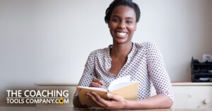 Client or Coach pondering Career Ideas writing in journal