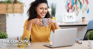 Coach thinking creatively at desk with mug