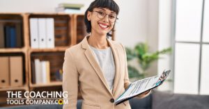 Coach in office with Life Coaching Welcome Packet Letter on Clipboard