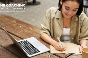 Young female coach journaling