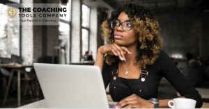 Female coach sitting thoughtfully, reflecting on personal and professional growth