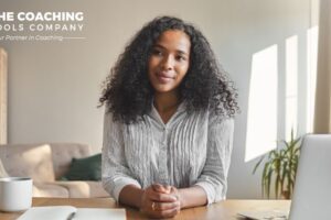 Woman at tidy workspace, coffee and planner nearby, setting New Year goals