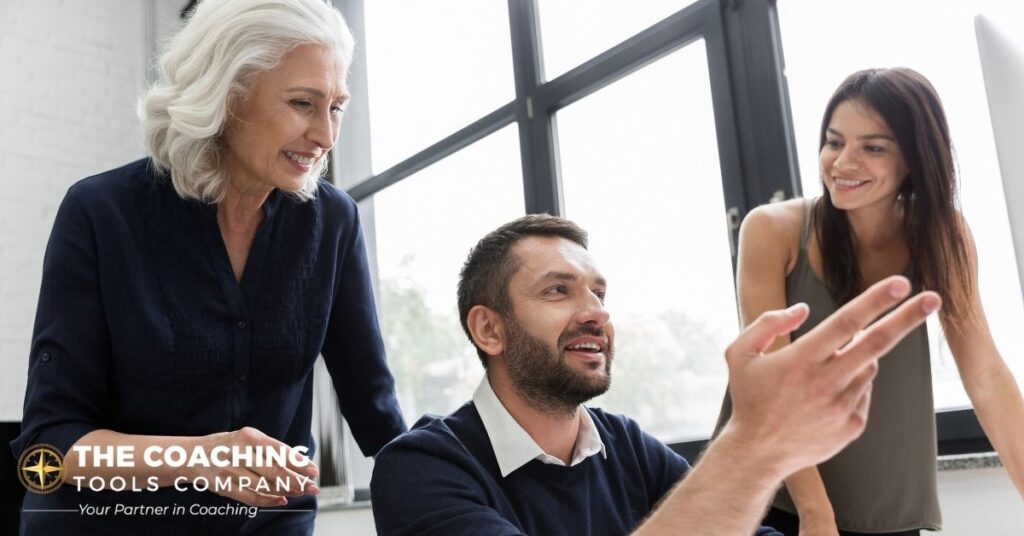 A team collaborating around a screen, reflecting shared coaching capacity in the era of AI.
