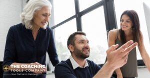 A team collaborating around a screen, reflecting shared coaching capacity in the era of AI.