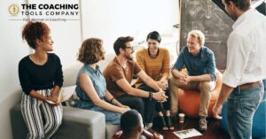Professionals participating in a team coaching session focused on collaboration and shared goals