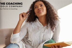 Coach reflecting with a journal as part of a self-care practice