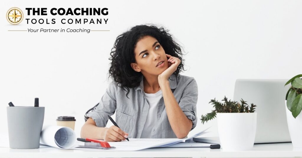 Woman reflecting on her thoughts while working at a desk