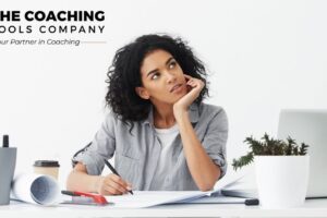 Woman reflecting on her thoughts while working at a desk